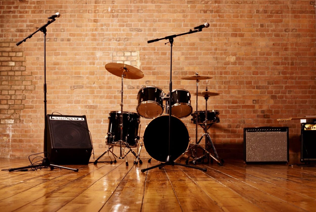 A room with a brick wall and wooden floors.